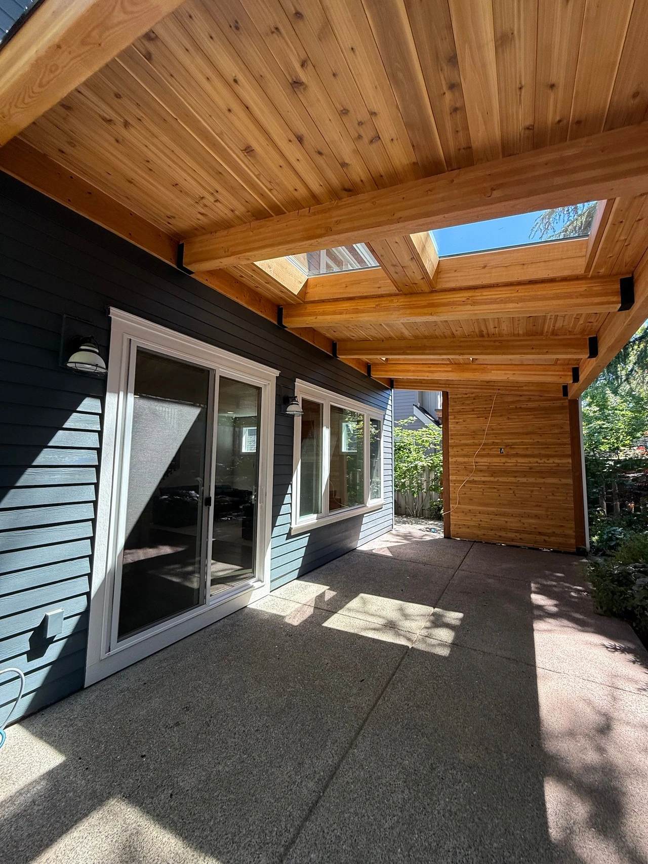 Patio cover over a sliding door and concrete patio