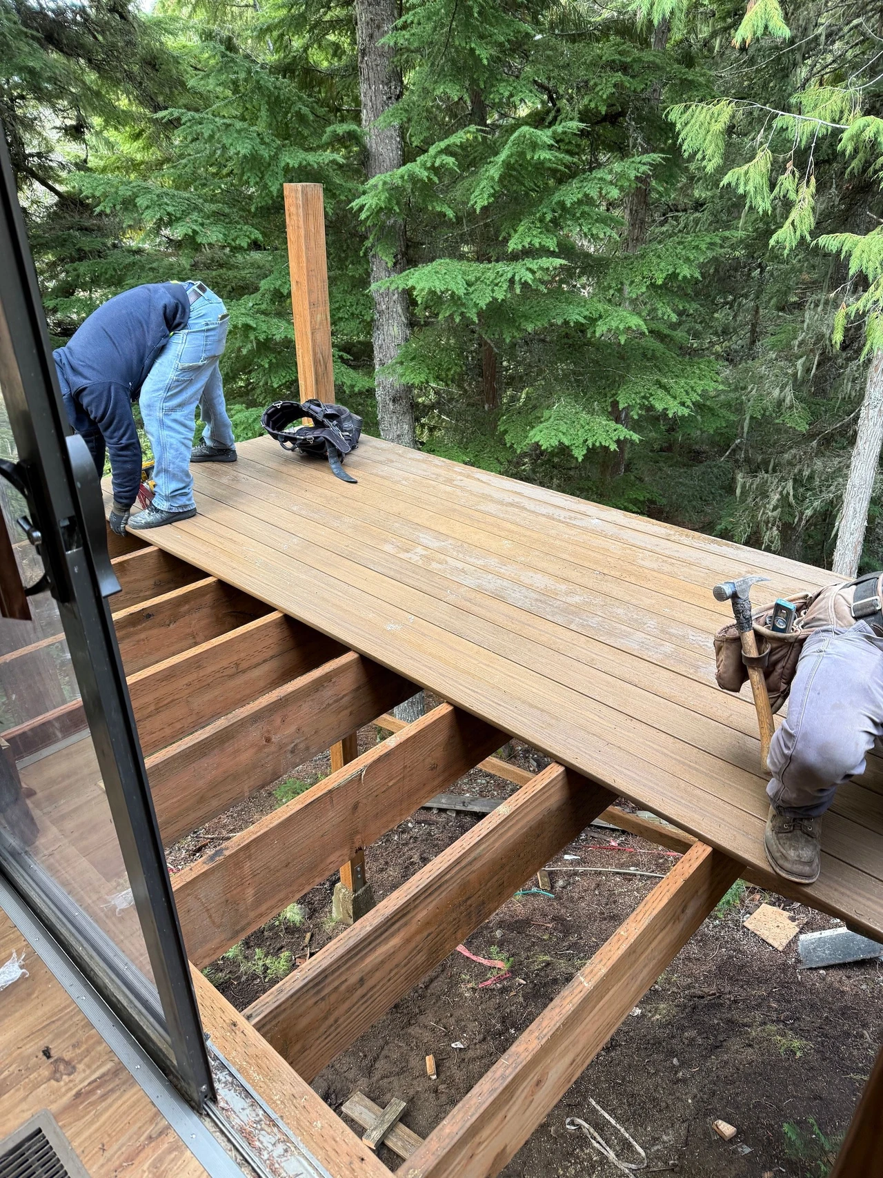 Workers installing boards on a deck