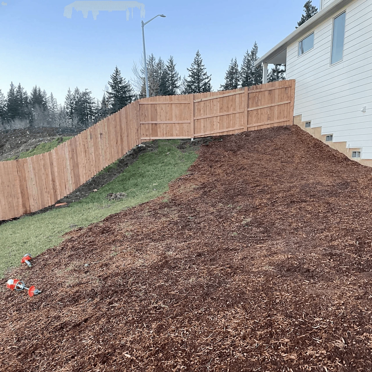 Earthy colored wood fence built on a hillside