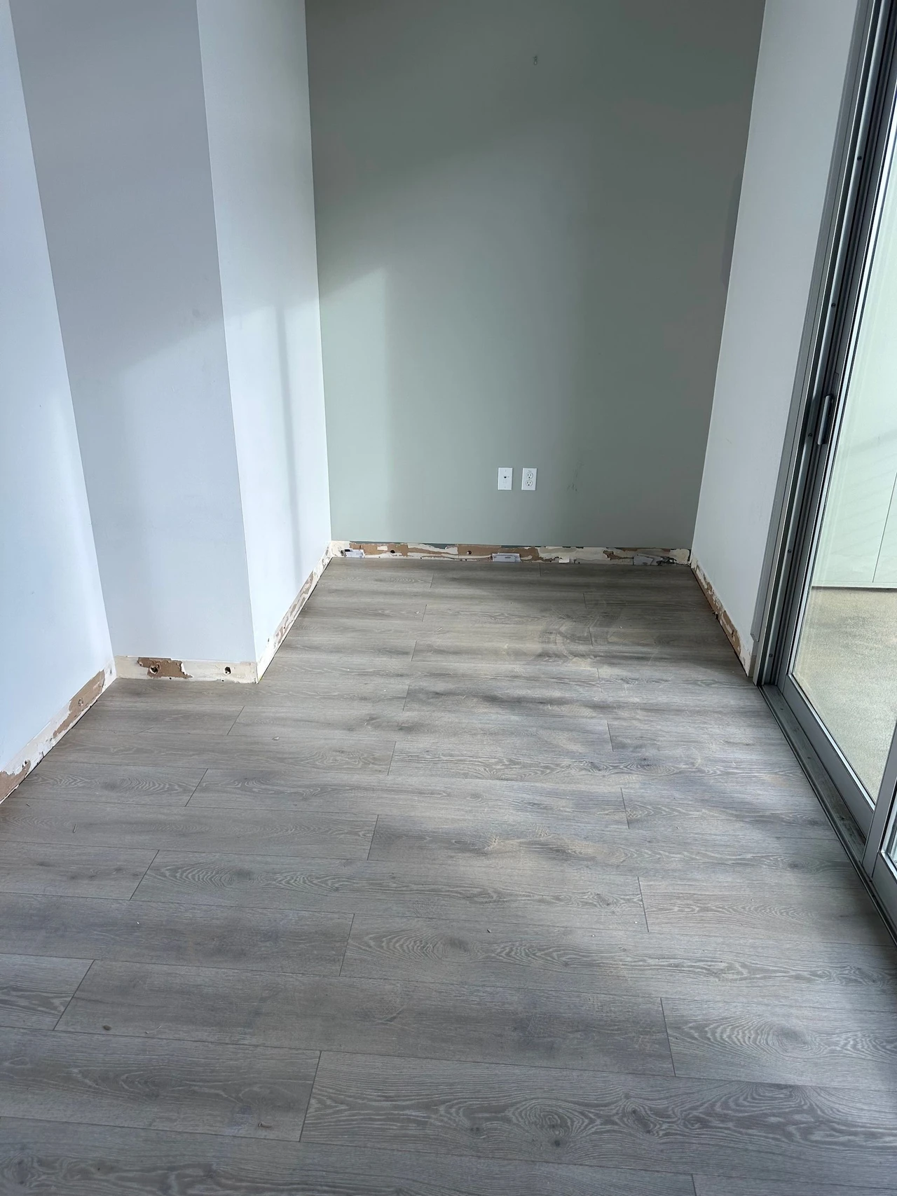 Small office space with gray laminate flooring