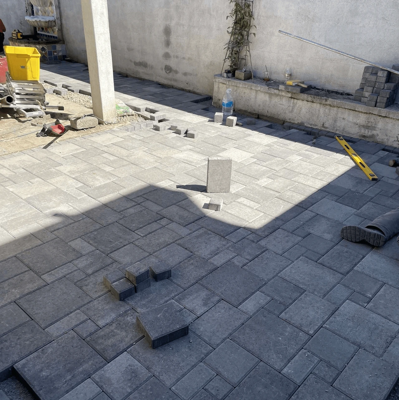 Backyard being filled in with pavers, about halfway done