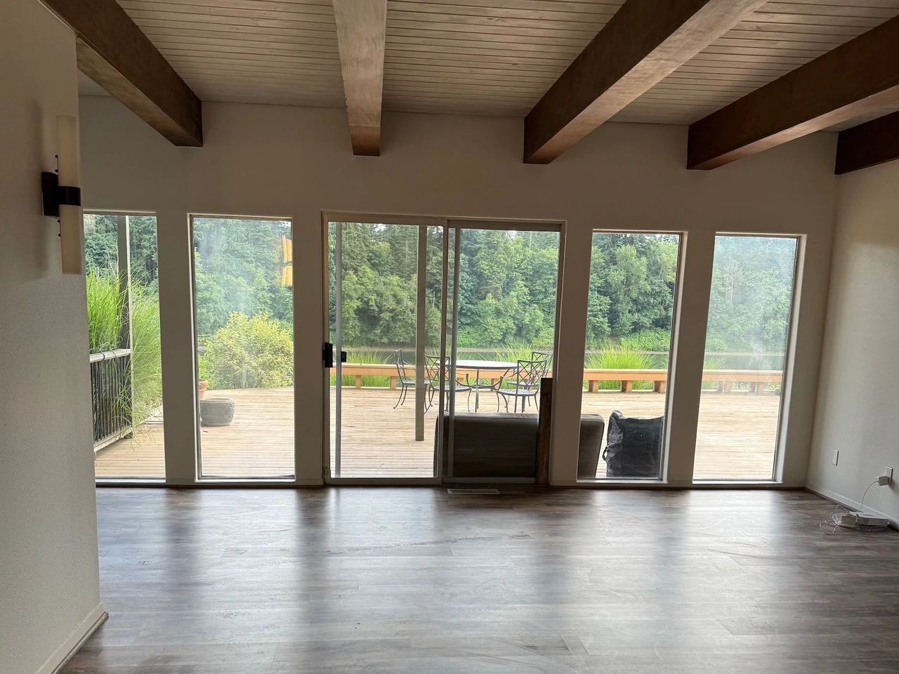 Living room with white walls and brown wood flooring