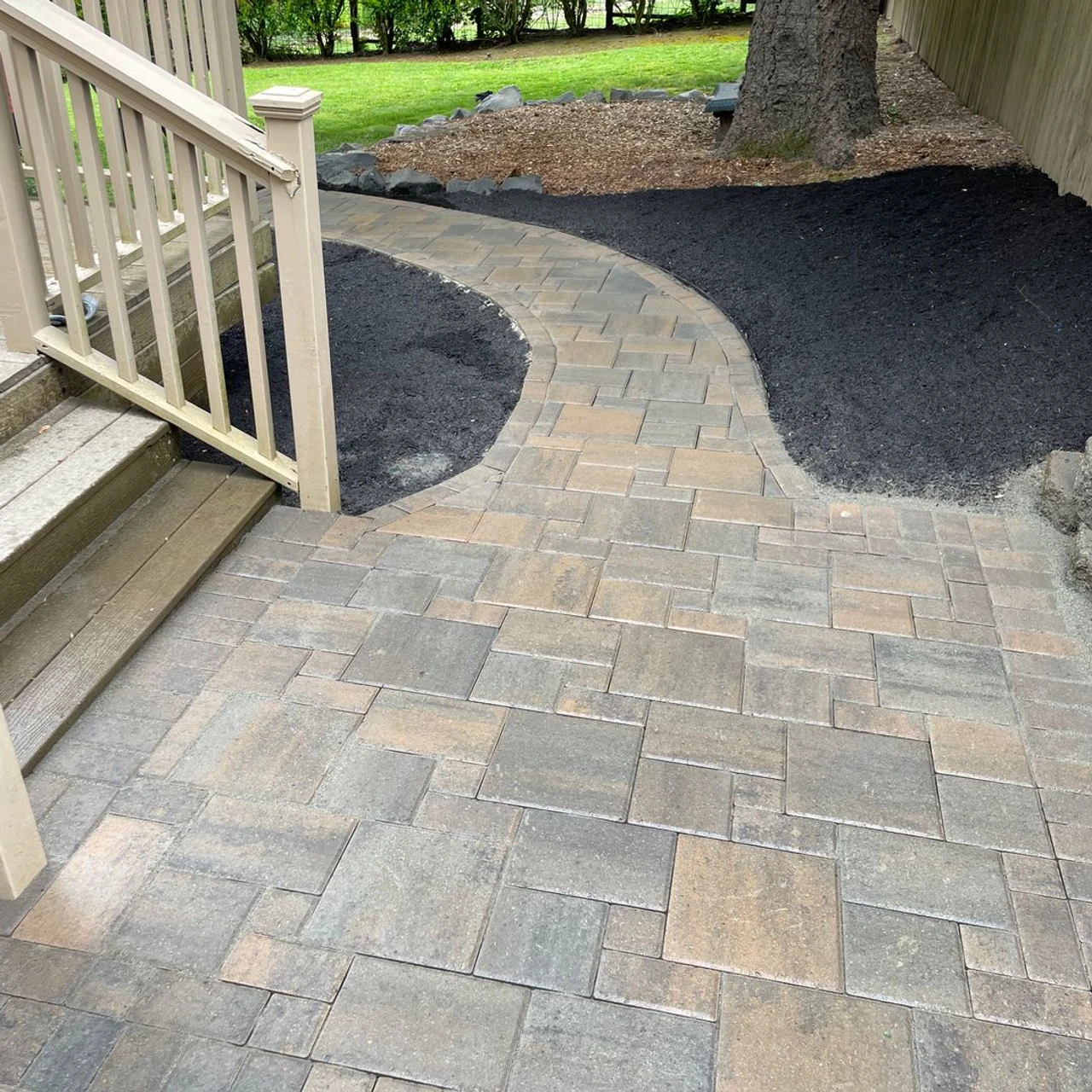 Paver pathway going down the side of a property