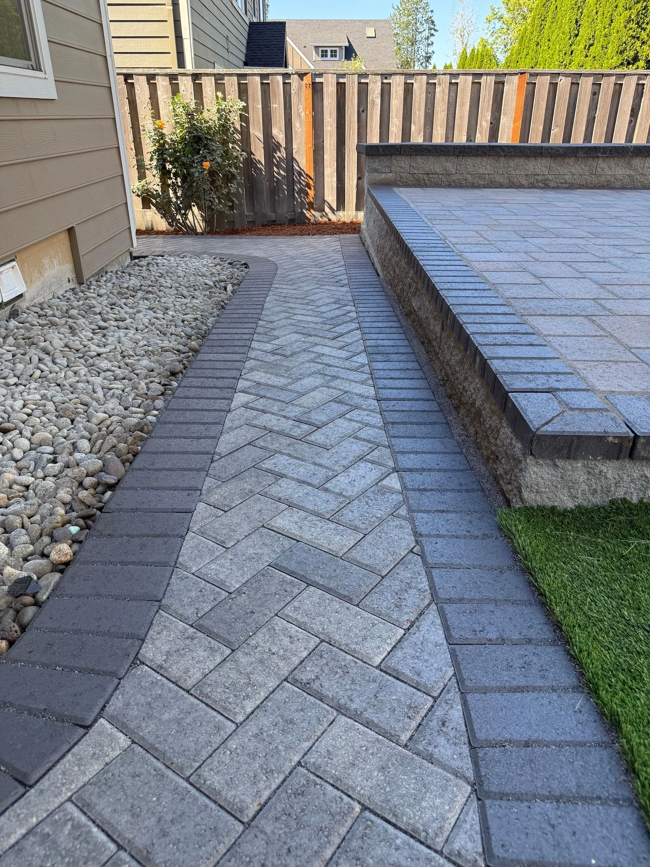 Paver walkway at the base of a house