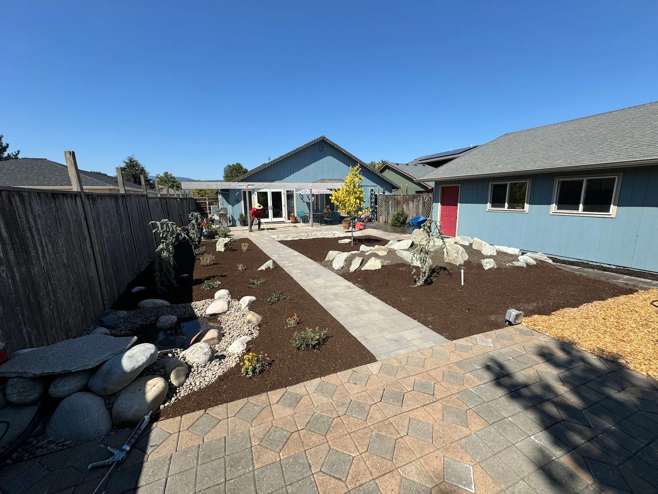 cement walkway with bark landscaping on both sides