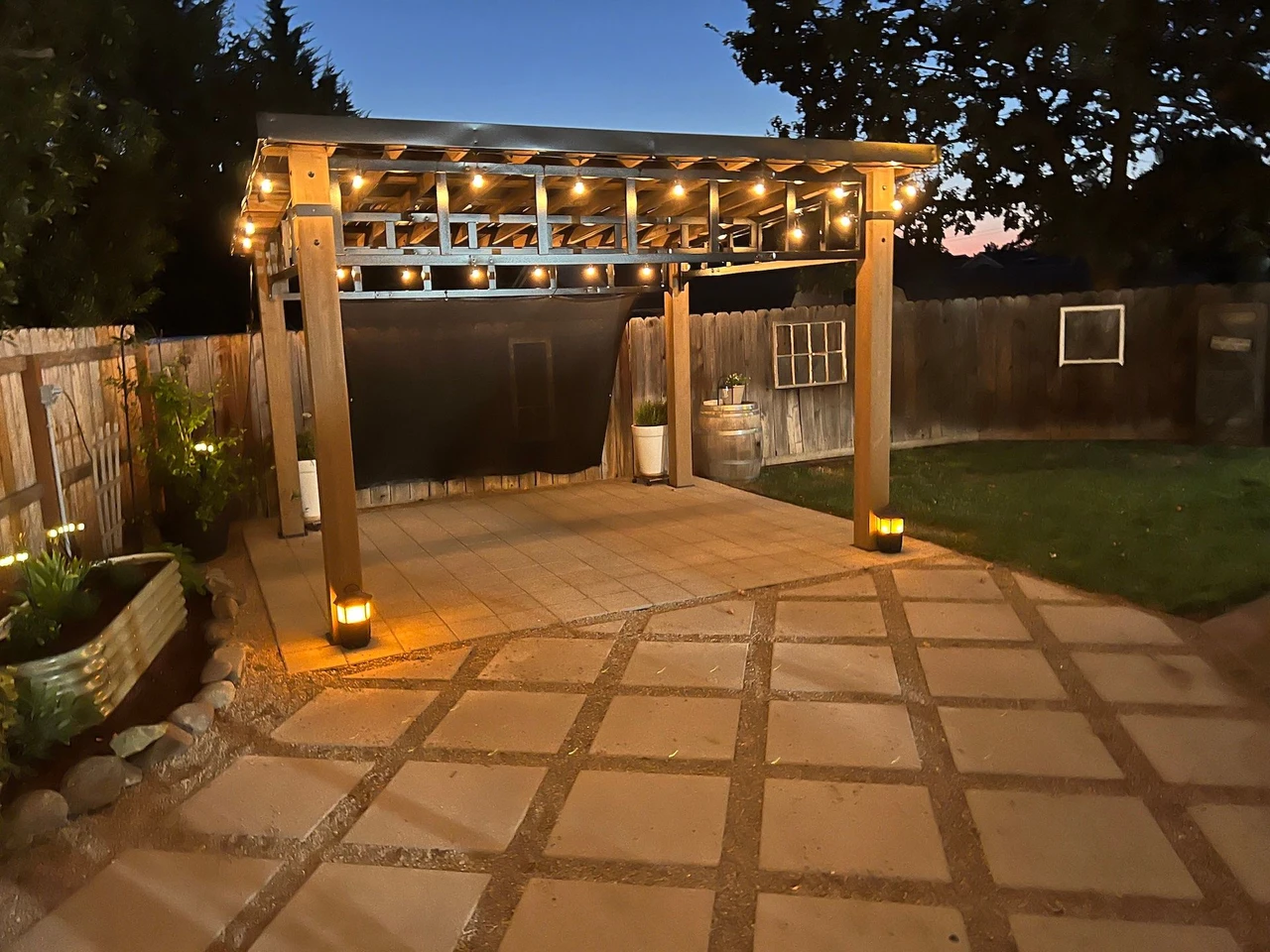 Landscaped backyard featuring a gazebo and paver patio