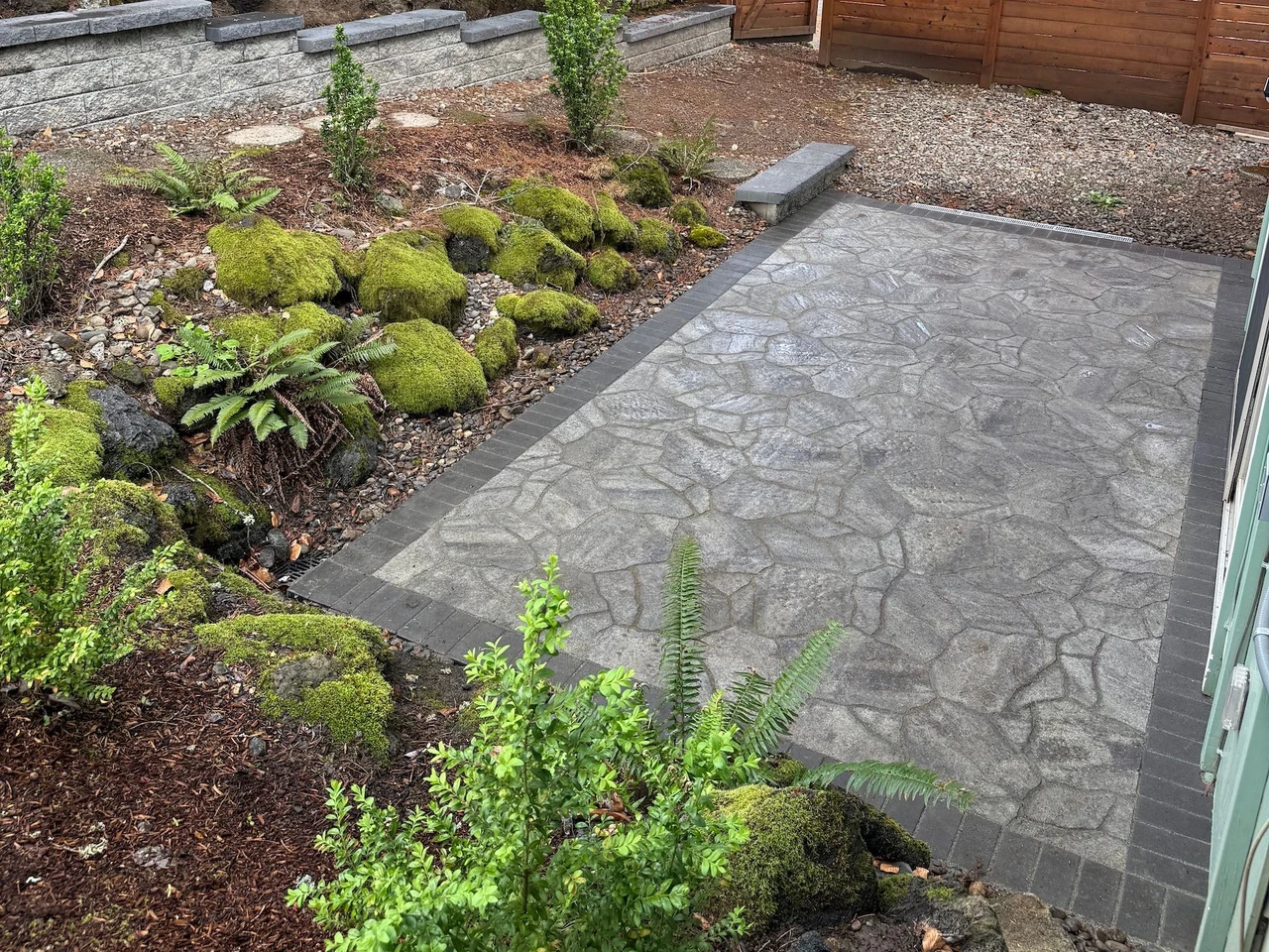 Custom stone patio with bark, plants and stone around