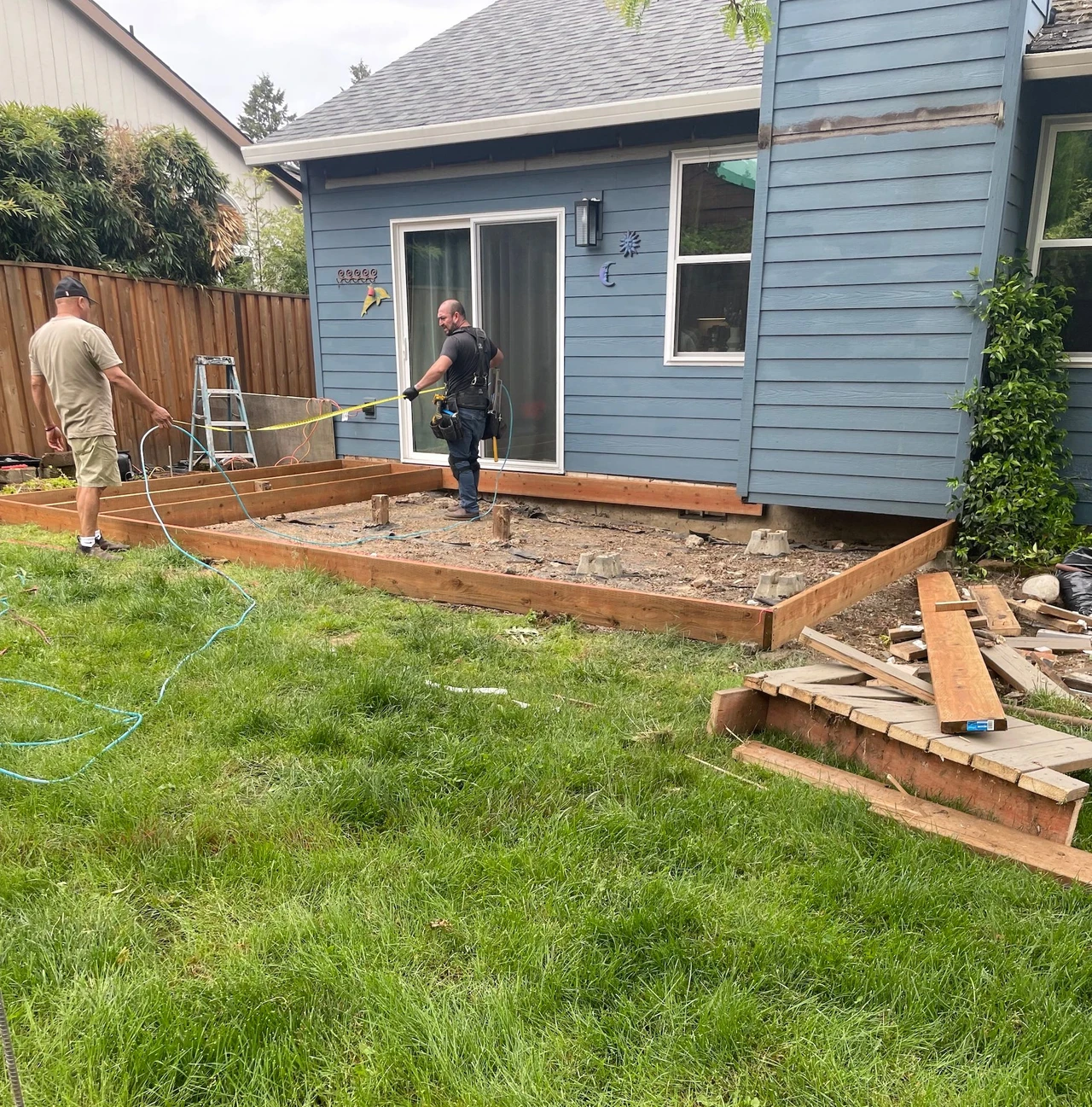Wooden deck base being installed in a back yard