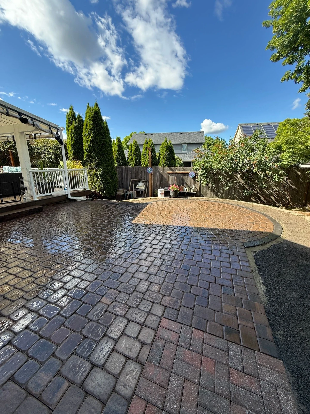 Paver patio with circular shape in the end and trees in the background