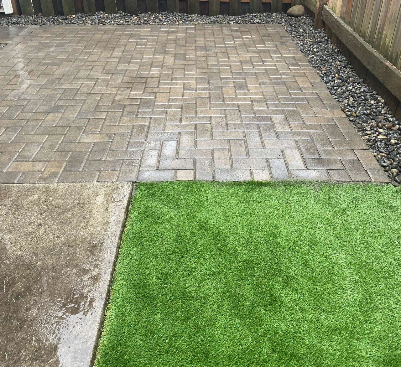 Paver patio with a piece of turf in the corner