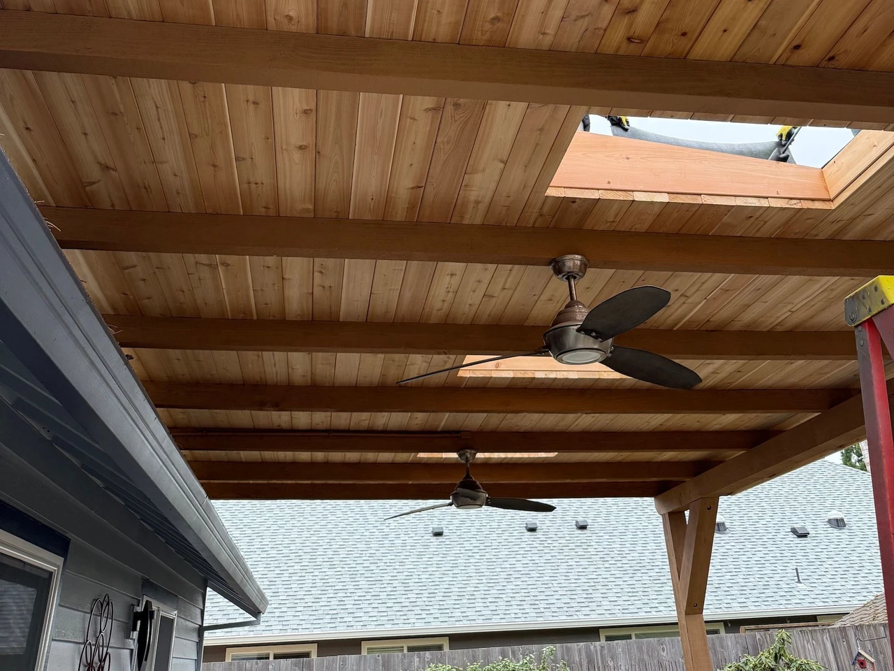 Wooden porch cover with a ceiling fan