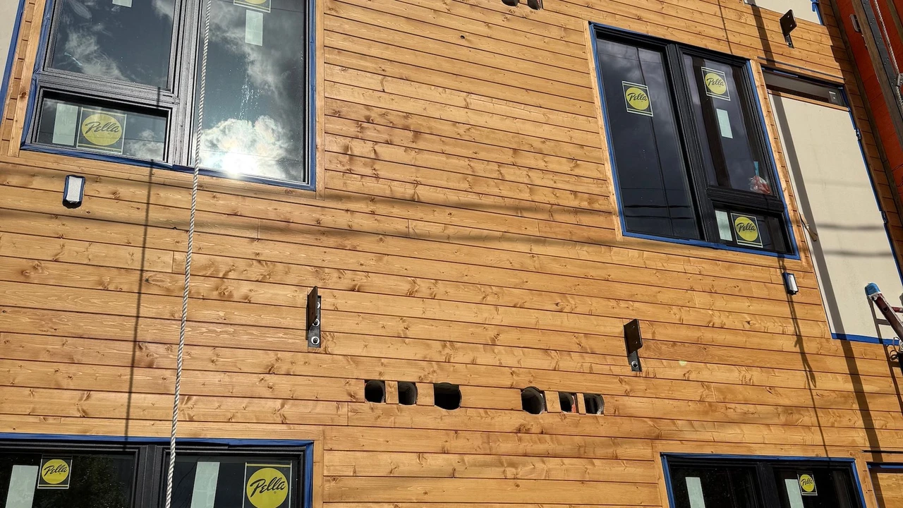 Apartment building with recently installed wood siding
